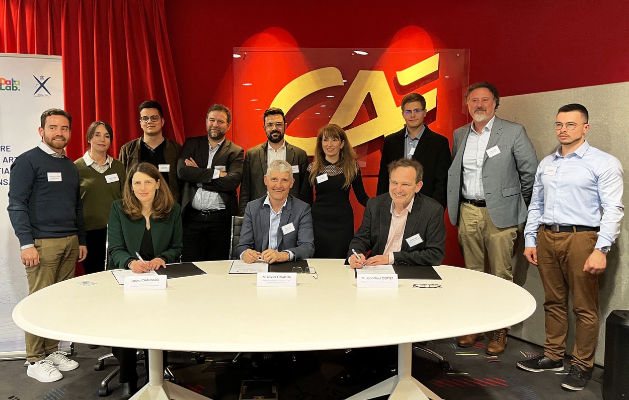 Group photo of the signing parties and their team.